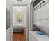 Hallway view of laundry closet with stacked washer and dryer and bedroom in the background at 3632 Calabria Ave, Davenport, FL 33897
