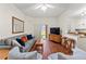 Comfortable living room with hardwood floors, a plush sofa, and a sliding door to the outdoor patio at 3632 Calabria Ave, Davenport, FL 33897