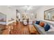 Inviting living room featuring hardwood floors, a comfortable gray sofa, and stylish decor at 3632 Calabria Ave, Davenport, FL 33897