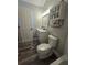 Bathroom with vanity, toilet, and wood-look floors at 4002 August Ct, Casselberry, FL 32707