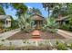 Quaint bungalow with a brick walkway, lush landscaping, and mature palm trees at 415 N Shine Ave, Orlando, FL 32803