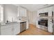 Modern kitchen featuring white cabinets, stainless steel appliances, and sleek countertop at 4290 Minoso St, Orlando, FL 32811