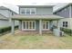 House back view with covered patio and brick pavers at 530 Windy Pine Way, Oviedo, FL 32765