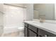 Bathroom with white tiled shower, dark vanity, and white toilet at 530 Windy Pine Way, Oviedo, FL 32765