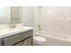 Clean bathroom with white tiled shower and dark vanity at 530 Windy Pine Way, Oviedo, FL 32765