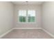 Bright bedroom with carpeted floor and two windows at 530 Windy Pine Way, Oviedo, FL 32765