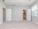 Main bedroom with carpet, neutral walls, and access to the en-suite bathroom at 530 Windy Pine Way, Oviedo, FL 32765
