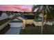 Aerial view of a single-story house with solar panels and a landscaped yard at 5504 Hamlin Close Rd, Davenport, FL 33896