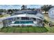 Aerial view: home with solar panels and a refreshing, screened pool at 5504 Hamlin Close Rd, Davenport, FL 33896