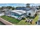 Aerial view: home with solar panels and screened pool with firepit at 5504 Hamlin Close Rd, Davenport, FL 33896