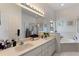 Elegant bathroom with double vanity, soaking tub, and separate shower at 5504 Hamlin Close Rd, Davenport, FL 33896