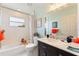 Bathroom with tub, shower, and dark vanity at 5504 Hamlin Close Rd, Davenport, FL 33896