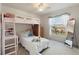 Bedroom with bunk bed, desk, and backyard view at 5504 Hamlin Close Rd, Davenport, FL 33896
