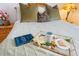 Close-up of a bedspread with a tray of coffee and cookies at 5504 Hamlin Close Rd, Davenport, FL 33896