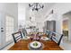 Elegant dining room with a wooden table, and views into the kitchen and Gathering room at 5504 Hamlin Close Rd, Davenport, FL 33896