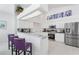 Modern kitchen with white cabinets, granite countertops, and stainless steel appliances at 5504 Hamlin Close Rd, Davenport, FL 33896