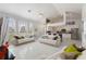 Open living room and kitchen with vaulted ceilings and white marble floors at 5504 Hamlin Close Rd, Davenport, FL 33896