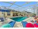 Refreshing pool with covered patio and lounge chairs at 5504 Hamlin Close Rd, Davenport, FL 33896