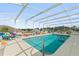 Inviting pool area with covered lanai, ample seating, and a refreshing blue pool at 5504 Hamlin Close Rd, Davenport, FL 33896