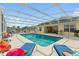 Sparkling pool with plenty of lounge chairs and a screened enclosure at 5504 Hamlin Close Rd, Davenport, FL 33896