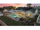 Aerial view of a home with a screened-in pool and fire pit area at 5504 Hamlin Close Rd, Davenport, FL 33896