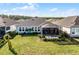 House with a large backyard, screened patio, and lush landscaping at 636 Mosaic Blvd, Daytona Beach, FL 32124