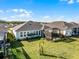House with a large backyard, screened patio, and lush landscaping at 636 Mosaic Blvd, Daytona Beach, FL 32124