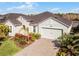 One-story house with light green exterior, landscaping and paver driveway at 636 Mosaic Blvd, Daytona Beach, FL 32124