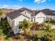 One story home with light green exterior, landscaping, and paver driveway at 636 Mosaic Blvd, Daytona Beach, FL 32124
