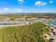 Aerial view showing a house nestled in a wooded area near a lake at 636 Mosaic Blvd, Daytona Beach, FL 32124