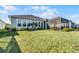 Landscaped backyard with large screened patio at 636 Mosaic Blvd, Daytona Beach, FL 32124