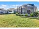 Landscaped backyard with large screened patio at 636 Mosaic Blvd, Daytona Beach, FL 32124