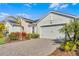 One-story home with light green exterior, landscaping, and paver driveway at 636 Mosaic Blvd, Daytona Beach, FL 32124