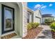 House entrance with a stone accent wall and a black door at 636 Mosaic Blvd, Daytona Beach, FL 32124