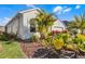 Light green house with palm trees and landscaping at 636 Mosaic Blvd, Daytona Beach, FL 32124