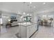 Open kitchen with large island, stainless steel appliances and adjacent dining area at 636 Mosaic Blvd, Daytona Beach, FL 32124