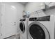 Laundry room with washer, dryer, and shelving at 636 Mosaic Blvd, Daytona Beach, FL 32124