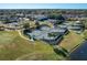 A scenic aerial shot shows multiple tennis courts in a community with lush landscaping and a lakeside view at 661 Cricklewood Ter, Lake Mary, FL 32746
