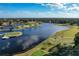 Panoramic aerial view of a beautiful community featuring a lake and a manicured golf course at 661 Cricklewood Ter, Lake Mary, FL 32746