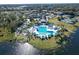 A scenic aerial view of a community pool, featuring lounging areas, cabanas, and lush landscaping at 661 Cricklewood Ter, Lake Mary, FL 32746