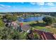 Aerial shot showcases a home adjacent to a serene lake and lush golf course, with beautiful landscaping at 661 Cricklewood Ter, Lake Mary, FL 32746