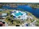 Stunning aerial view of a community pool and recreational area, set against a beautiful lake backdrop at 661 Cricklewood Ter, Lake Mary, FL 32746