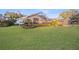 The large backyard features lush landscaping, a screened-in pool, and a detached pool house at 661 Cricklewood Ter, Lake Mary, FL 32746