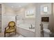 Bright bathroom with a garden tub, marble surround, and a window with plantation shutters at 661 Cricklewood Ter, Lake Mary, FL 32746