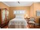 Inviting bedroom with patterned bedding, decorative armoire and plantation shutters at 661 Cricklewood Ter, Lake Mary, FL 32746