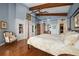 Bedroom with beamed ceilings, four-poster bed, hardwood floors, built in storage, and tranquil views at 661 Cricklewood Ter, Lake Mary, FL 32746