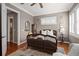 Well-lit bedroom with plantation shutters, hardwood floors, and comfortable furniture at 661 Cricklewood Ter, Lake Mary, FL 32746