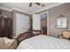 Light-filled bedroom with white linens, hard wood floors and neutral decor at 661 Cricklewood Ter, Lake Mary, FL 32746