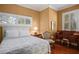 Comfortable bedroom featuring a bright window, wood floors, and a cozy queen bed with stylish bedding at 661 Cricklewood Ter, Lake Mary, FL 32746