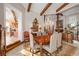 Dining room with beamed ceilings, a chandelier, and views of the kitchen and staircase at 661 Cricklewood Ter, Lake Mary, FL 32746